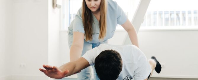Physical therapist guiding a patient through a bird-dog core stability exercise in a bright clinic